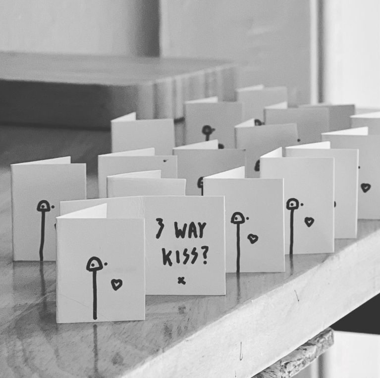 Small cards with '3 way kiss?' written on them